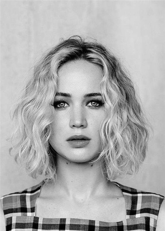 jennifer lawrence s svojim zamegljenim kvadratnim rezom z lahkimi kodri na plaži, romantično vintage pričesko