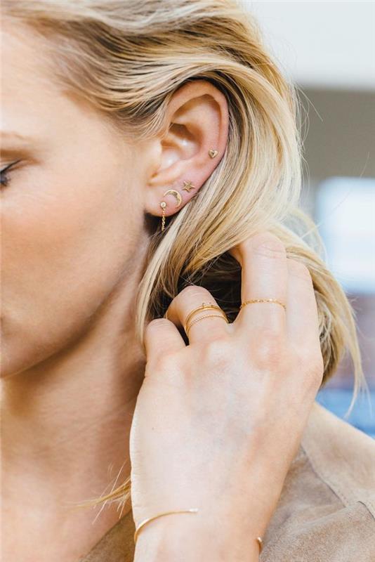 prebadanje ušes, zlati nakit, blond lasje, bež blazer, ženski piercing, srčni uhani