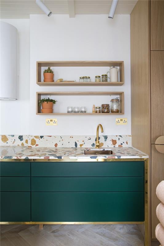 elegantiško dizaino anties žalia ir balta virtuvė, „Terrazzo“ išvaizdos darbo augalas, puikiai derantis prie šviesios medienos spalvos ir virtuvės spintelių