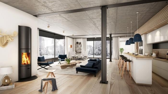 betonski strop leseni parket dnevna soba moderni industrijski slog črni kamin les in beli stol