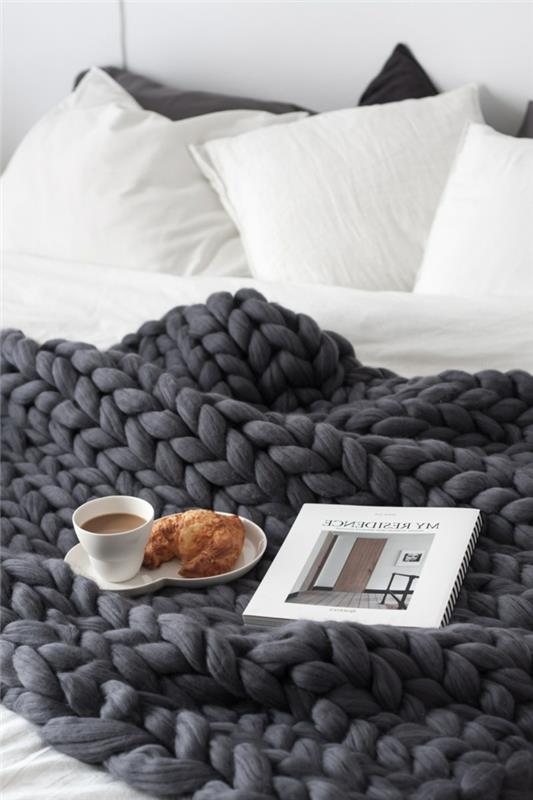 papuoškite savo skandinavišką miegamąjį, anglimi pilkai megztas pledas, puodelis kavos ir raguolių, baltos pagalvėlės