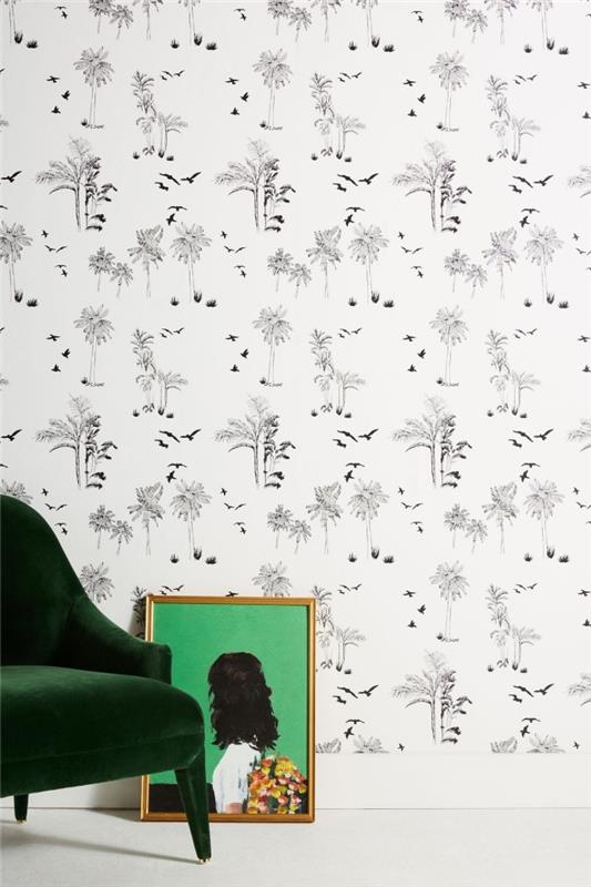 minimalistinė deko idėja su pigiais baltais ir juodais tapetais su paukščių ir augalų raštais su tamsiai žaliu foteliu