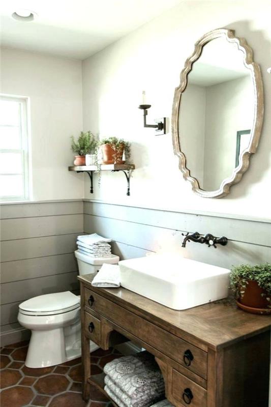 medinis stalas, veidrodis su dekoratyviniu rėmu, medinis stalas kaip praustuvo spintelė, senoviniai čiaupai, senovinė tualeto deko idėja