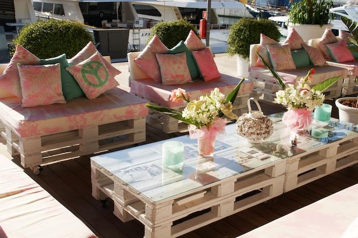palet koltuklarda pembe ve kirli beyaz palet bahçe minderi, cam üstlü palet sehpa, çiçek buketleri deco