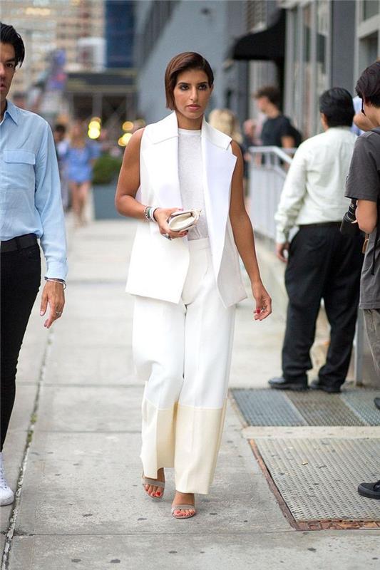 eleganten enobarvni videz v beli ženski obleki z blejzerjem brez rokavov