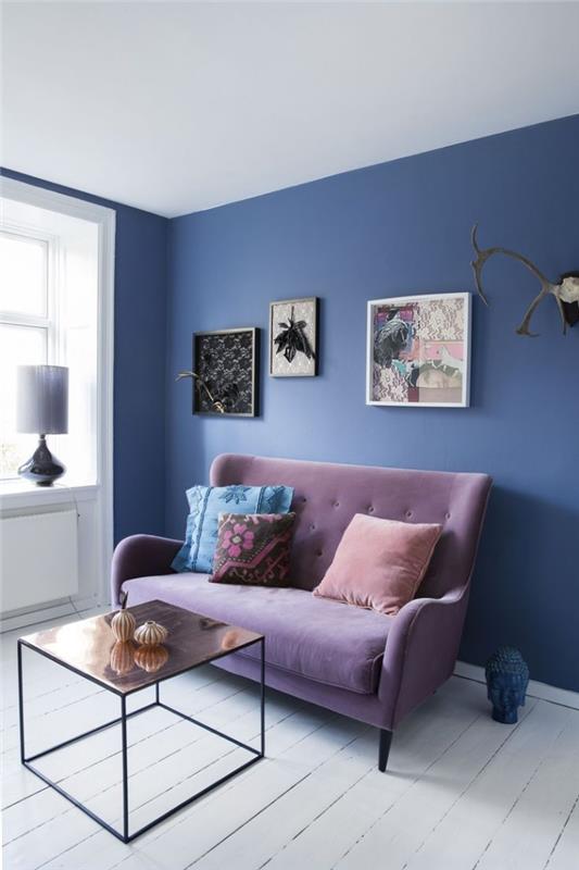 bir alanı büyütmek için hangi renk oturma odası duvarı, leylak rengi bir kanepe ile yüceltilmiş mavi vurgulu İskandinav bohem tarzında küçük oturma odası
