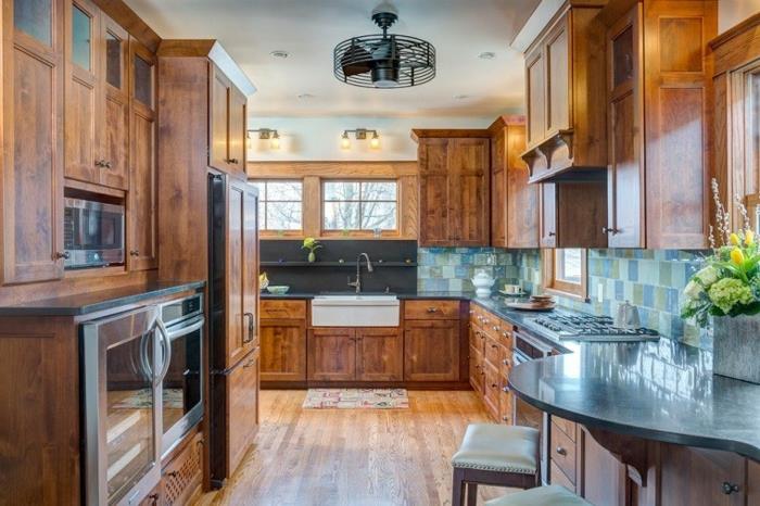 lesena kuhinja, lesene omare, vgrajena kuhinja, modri kuhinjski pult, karirano okno, leseni stolček