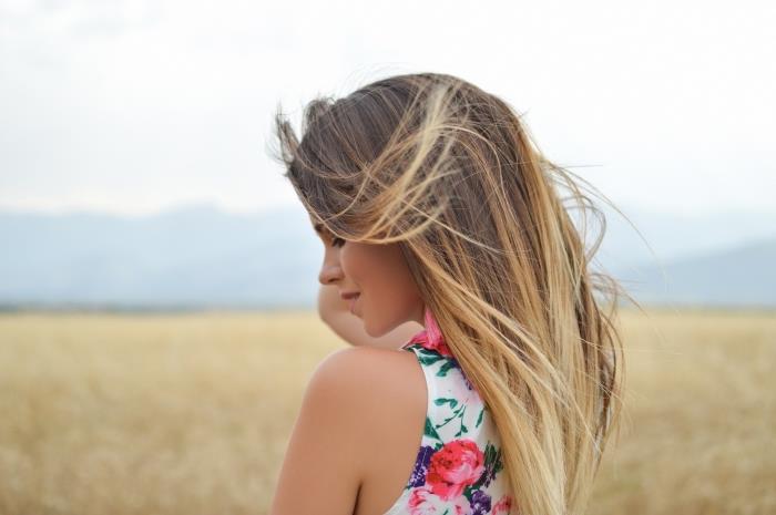 primer blond balayage na svetlo rjavih osnovnih dolgih ravnih laseh, model bele obleke z rožnatimi in zelenimi cvetličnimi vzorci
