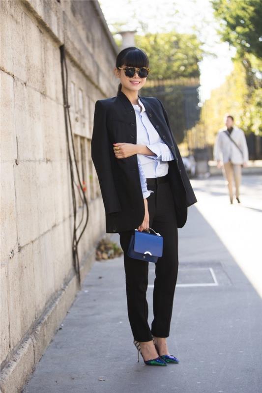 ženski model obleke za razgovor za službo v črnih ohlapnih hlačah in blazerju v kombinaciji z zelo svetlo modro srajco