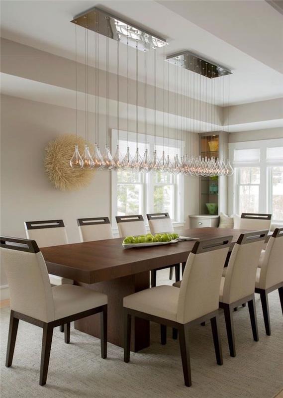velika pravokotna lesena jedilna miza v beli sobi in oblikovalska razsvetljava