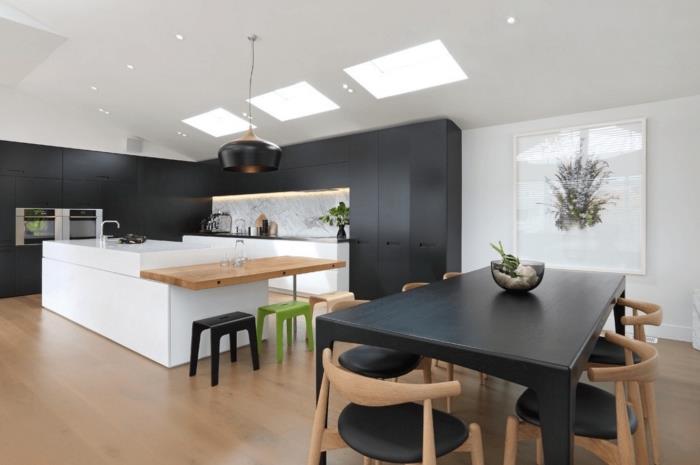 virtuvė prie valgomojo, įrengta matiniais juodais baldais su pilko ir balto marmuro dizaino atplaišomis
