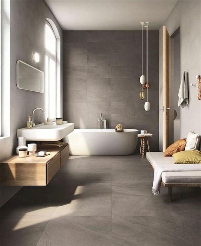 photo velika prostorna kopalnica s sivo betonsko talno in stensko klopjo ter velikim skandinavskim umivalnikom
