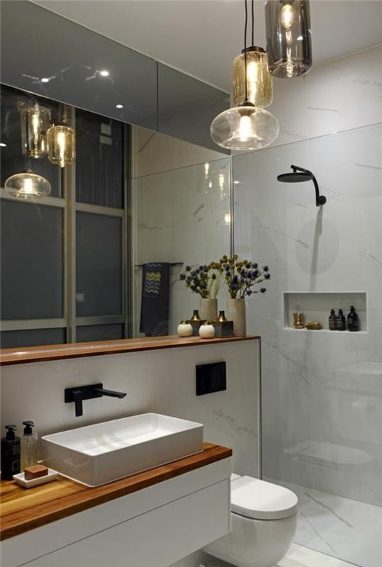 kokonuojantis vonios kambarys, minimalistinė erdvės apdaila, pakabinamos lempos, šviesiai pilkos plytelės