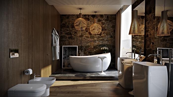 razkošna kopalnica, v kateri prevladujejo naravni materiali, z Zen kadjo na betonskem podiju, poudarjenem z naravnim kamnitim zidom