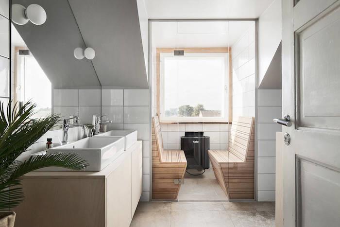 majhna kopalnica z nagnjenimi stropi v švedskem skandinavskem slogu z integrirano savno in dvojnim pravokotnim umivalnikom