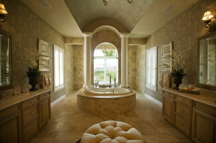 didelis miltelių kambarys, kreminė kėdė, sieniniai šviestuvai, smėlio spalvos travertino vonios kambarys