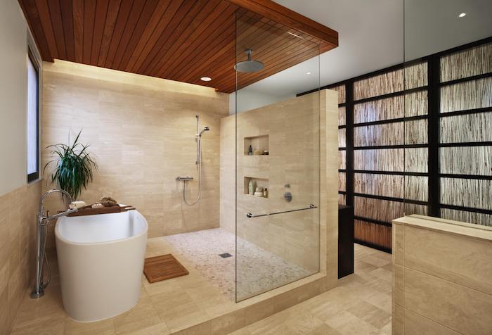 smėlio spalvos natūralaus akmens vonios kambarys su medinėmis lubomis plytelėmis išklota vonia juodi elementai