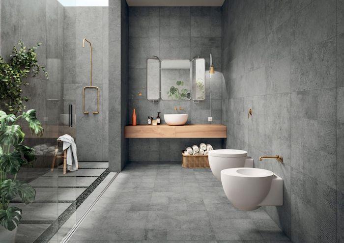 vonios kambario natūralaus akmens ir medžio sienos ir grindys iš tamsiai pilkos žalvario akcentuoja augalus vonios kambaryje