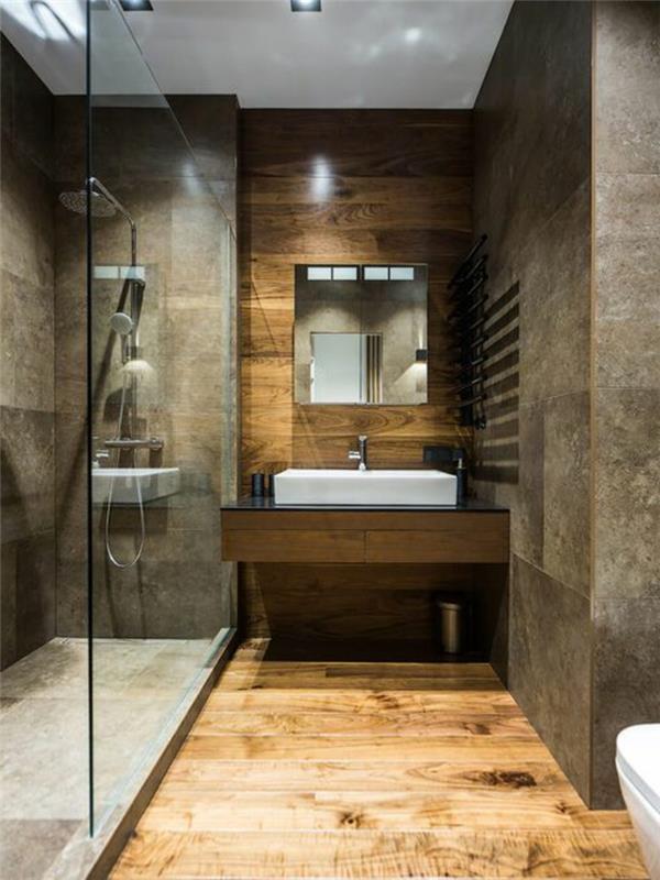 „Zen“ vonios kambarys, dušo kabina ir pilkai smėlio spalvos plytelės, medinė danga