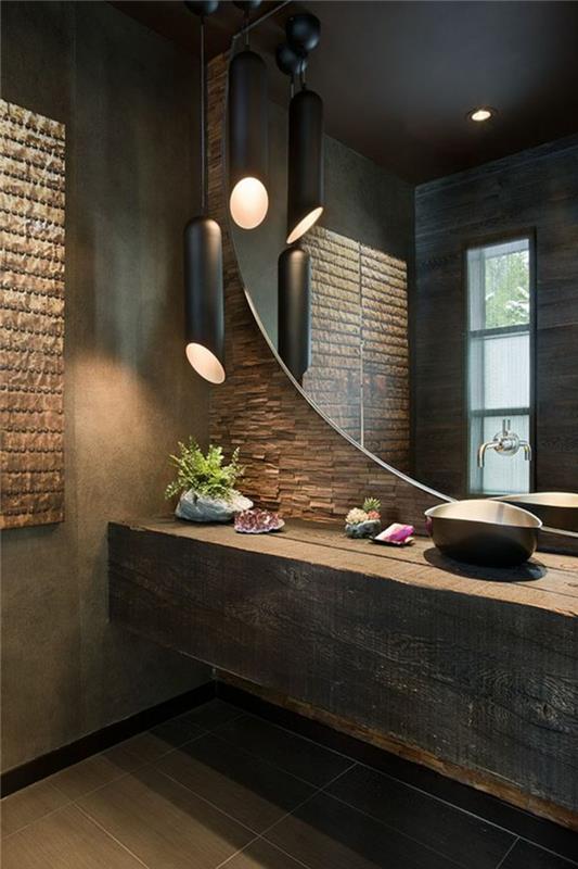 „Zen“ vonios kambarys, žalios medienos stalviršis, didelis apvalus sieninis veidrodis, cilindrinė lempa