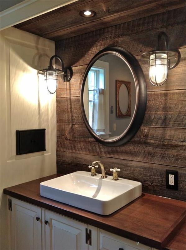 „Zen“ vonios kambarys, apvalus veidrodis ir pramoninio stiliaus narvo lempos, stačiakampė balta kriauklė