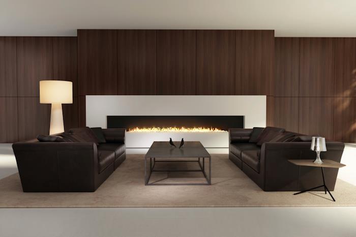 rudo bistre dizaino svetainė su rudomis odinėmis sofomis ir dideliu moderniu židiniu