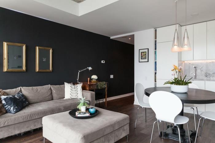 svetainė pilka, balta ir juoda, pilka kėdė, pilka sofa, svetainė ir virtuvė ovalus juodas stalas, baltos kėdės, kurias sienas dažyti spalva
