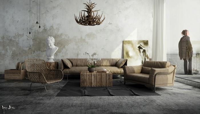 šiuolaikiškas dekoras, kaimiška pramoninė svetainė, dekoratyvinė elnių ragų pakaba, pilkas kilimas, pilkai ruda sofa ir fotelis, žalio medžio padėklų kavos staliukas, išblukusi siena