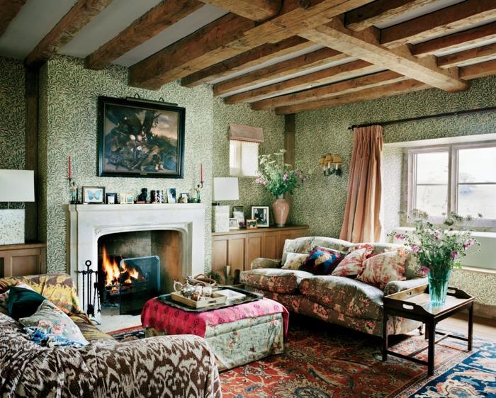 dnevna soba s pisanimi vzorci, otoman, kamin, zelene tapete, strop z gredami, barvita otrdela zofa, perzijska preproga, kamin