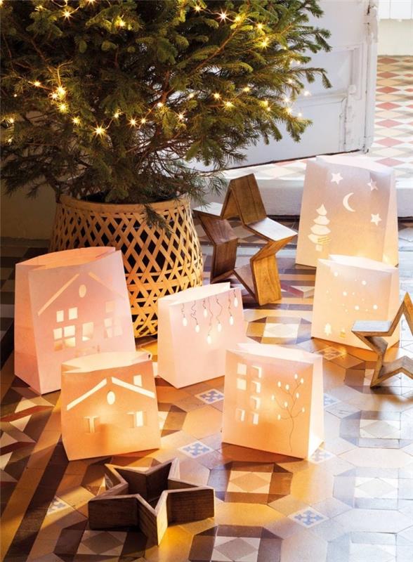Ağacın etrafına yere yerleştirilmiş led mumlarla kesilmiş kağıt cepli el yapımı Noel dekorasyonu
