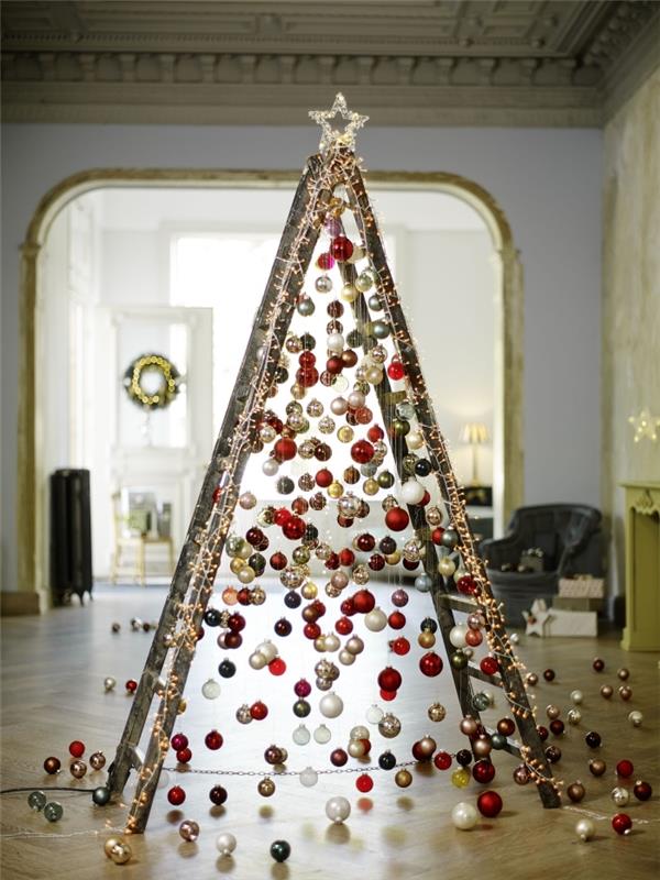 üstüne güzel bir yıldız yerleştirilmiş altın, beyaz ve kırmızı Noel toplarıyla kaplı orijinal bir Noel ağacına dönüştürülmüş ahşap bir merdiven