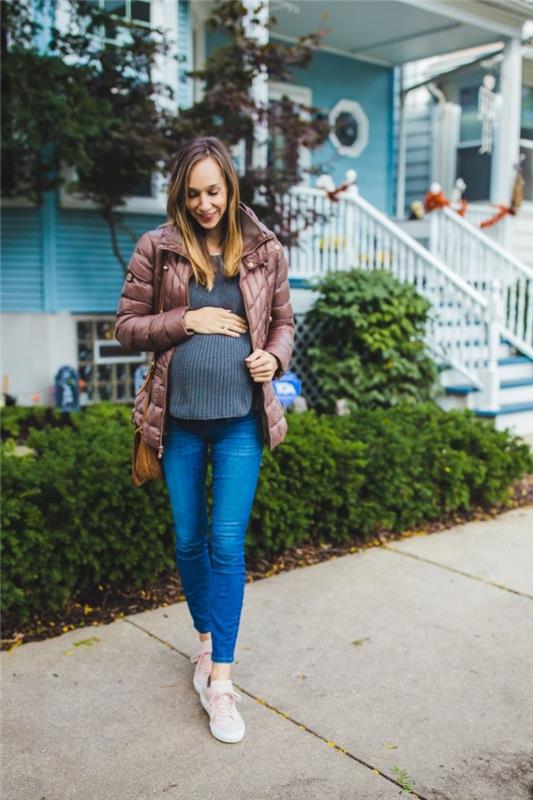 nėštumo drabužių idėja, kasdienio stiliaus nėščia moteris atrodo plonuose džinsuose su megztiniu ir baltais sportbačiais