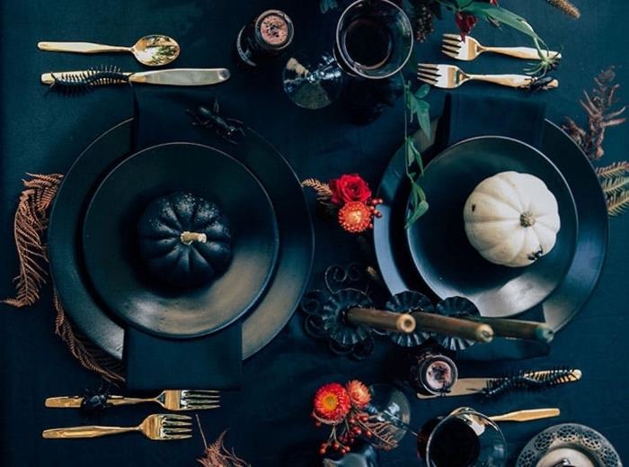 Siyah masa örtüsü, siyah tabaklar ve küçük dekoratif kabaklar ile Cadılar Bayramı için mumluklar ile Halloween masa düzenlemesi