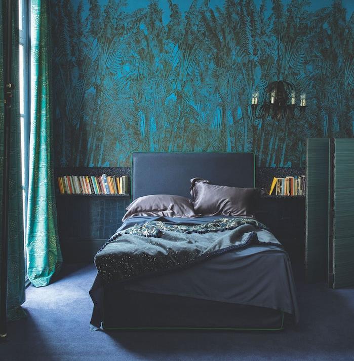 modra tapeta z džunglo v spalnici sive in modre barve z zelenimi zavesami in modro preprogo, elegantnim črnim lestencem