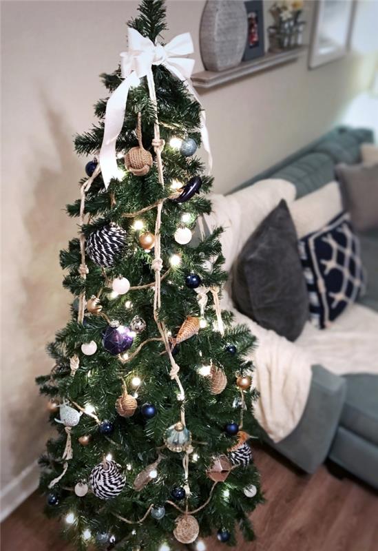 Deniz kenarı temalı süslerle süslenmiş Noel ağacı fikri, gri ve mavi su içi Noel dekorasyonu