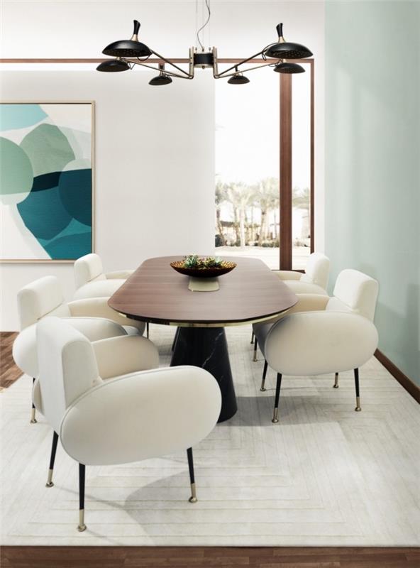 moda mobilyalarla döşenmiş nane yeşili duvarlı beyaz yemek odasında modern iç tasarım