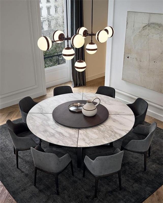 apvalus stalas-dizainas-pilkos kėdės-natūralus parketas-grindų dizainas-liustra-tamsiai pilka kilimas
