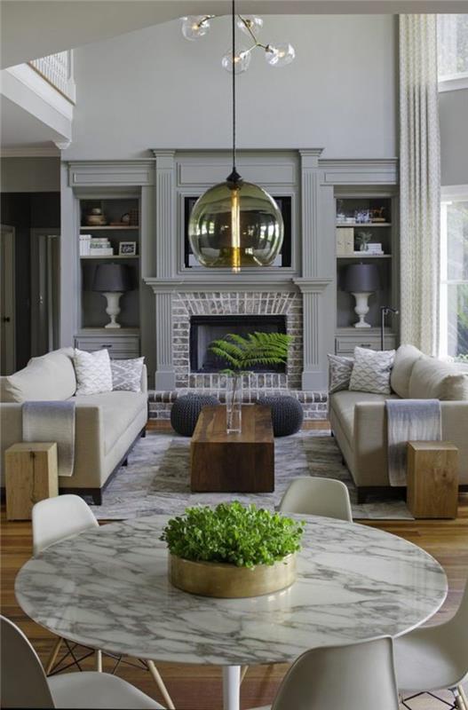 okrogla miza-imitacija-marmor-dnevna soba-20m2-bež-pohištvo-kamin-notranjost-kroglična svetilka