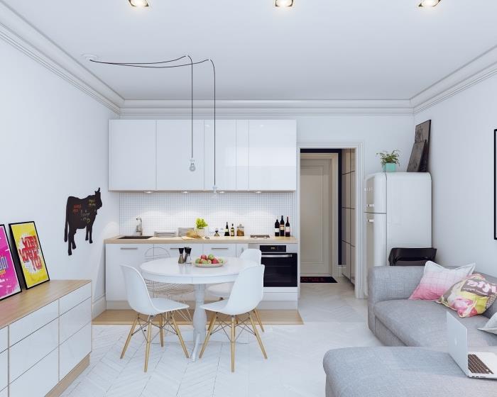 kuhinjski model, kuhinjsko pohištvo v belem in lesu brez ročajev, sivi kotni kavč z rožnatimi in rumenimi blazinami