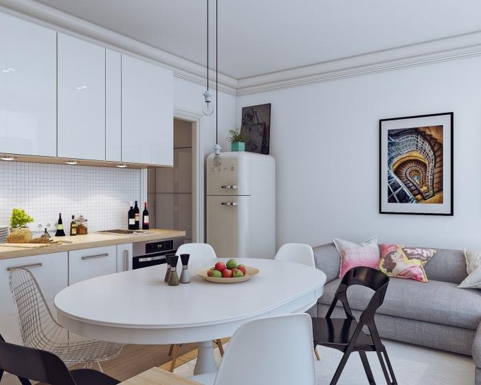 Skandinavski navdih, bela kuhinja s stenskimi enotami brez ročajev, siva zofa s skandinavskim dizajnom