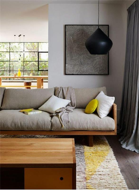 smėlio-geltonos spalvos kilimas-smėlio spalvos sofa-svetainė-baldai-rideuax-pilka-prašmatni-svetainė-kaip-susieti interjero spalvas