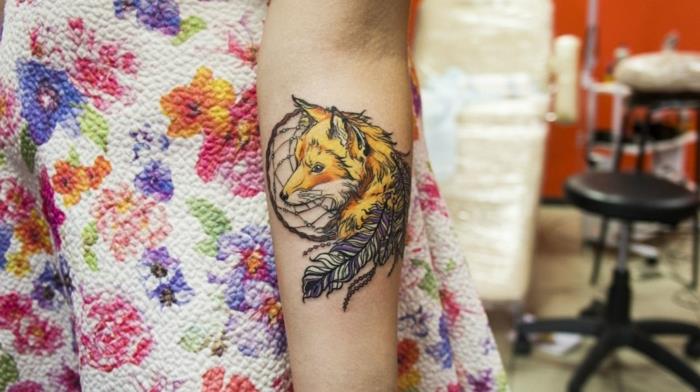 Dreamcatcher dövme önkol, siyah rüya kapanı, sarı ve mor tüyler ve turuncu sarı tilki tasarımı