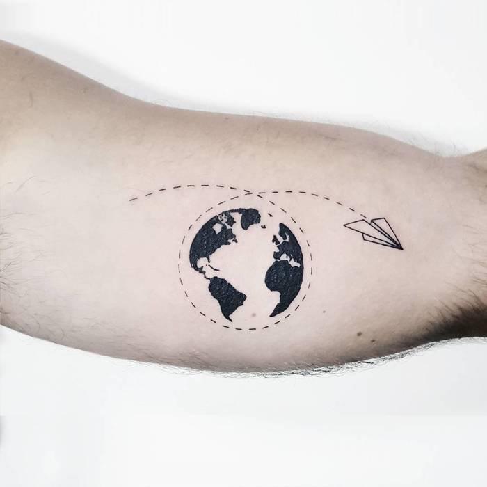 popierinis lėktuvas ir žemės tatuiruotė ant rankos