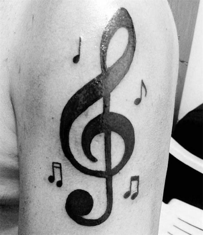 Muzikinė plyšio tatuiruotė ant didelės vyro rankos