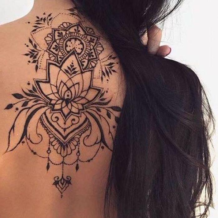 tetovaža lotosa in tetovaža mandale, črno črnilo, dolgi črni lasje, simbolični vzorci