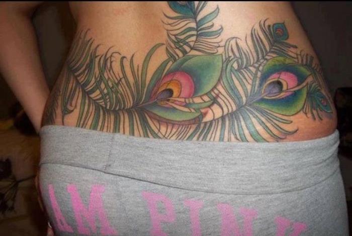 Tatuiruotės moteris apatinės nugaros povo plunksnų spalvos