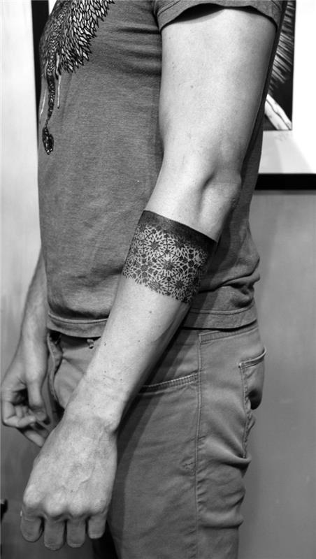 geometrijska tetovaža na traku z izvirnim dizajnom, ki igra na kontrastu med črnim trakom in vzorci rozete