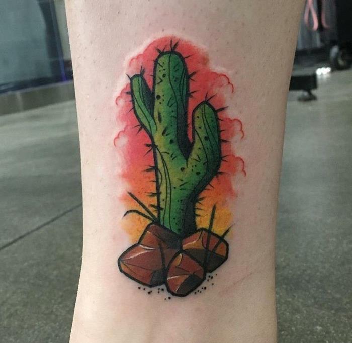 moteris veršelio tatuiruotė, kaktusas su akmenimis, meniškas kraštovaizdis, simbolizuojantis dykumą