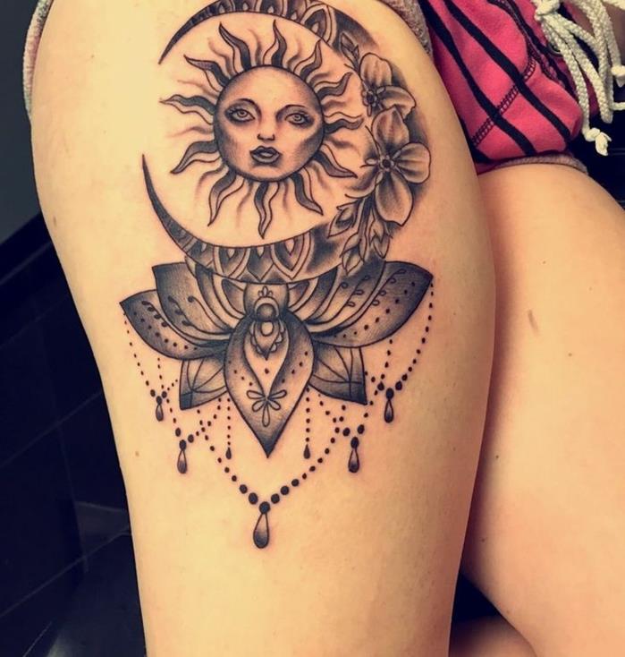 Saulės tatuiruotė, moters šlaunies tatuiruotė, saulės ir mėnulio personažai tatuiruoti ant šlaunies