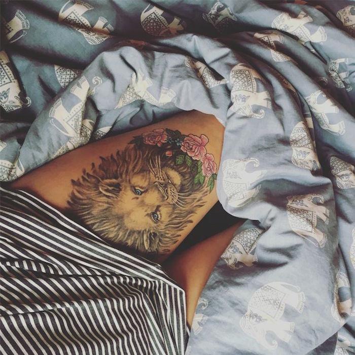 liūto galvos šlaunies tatuiruotė moterims